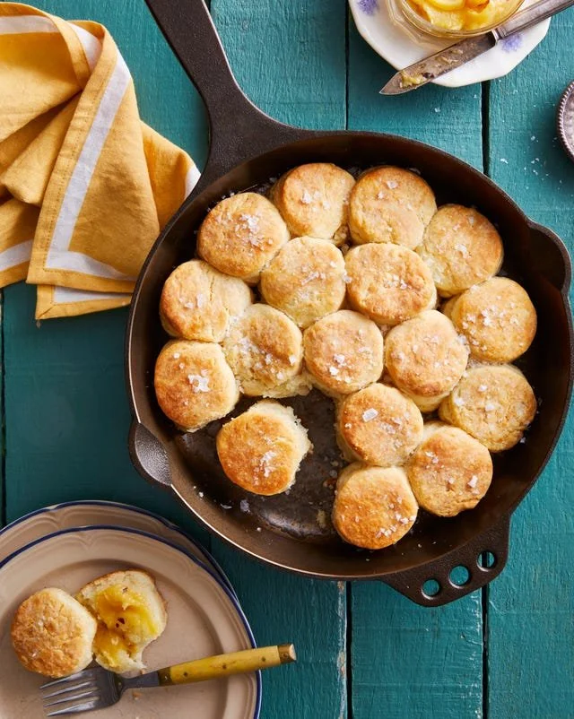 Skillet angel biscuits served with spicy honey butter for a flavorful breakfast.