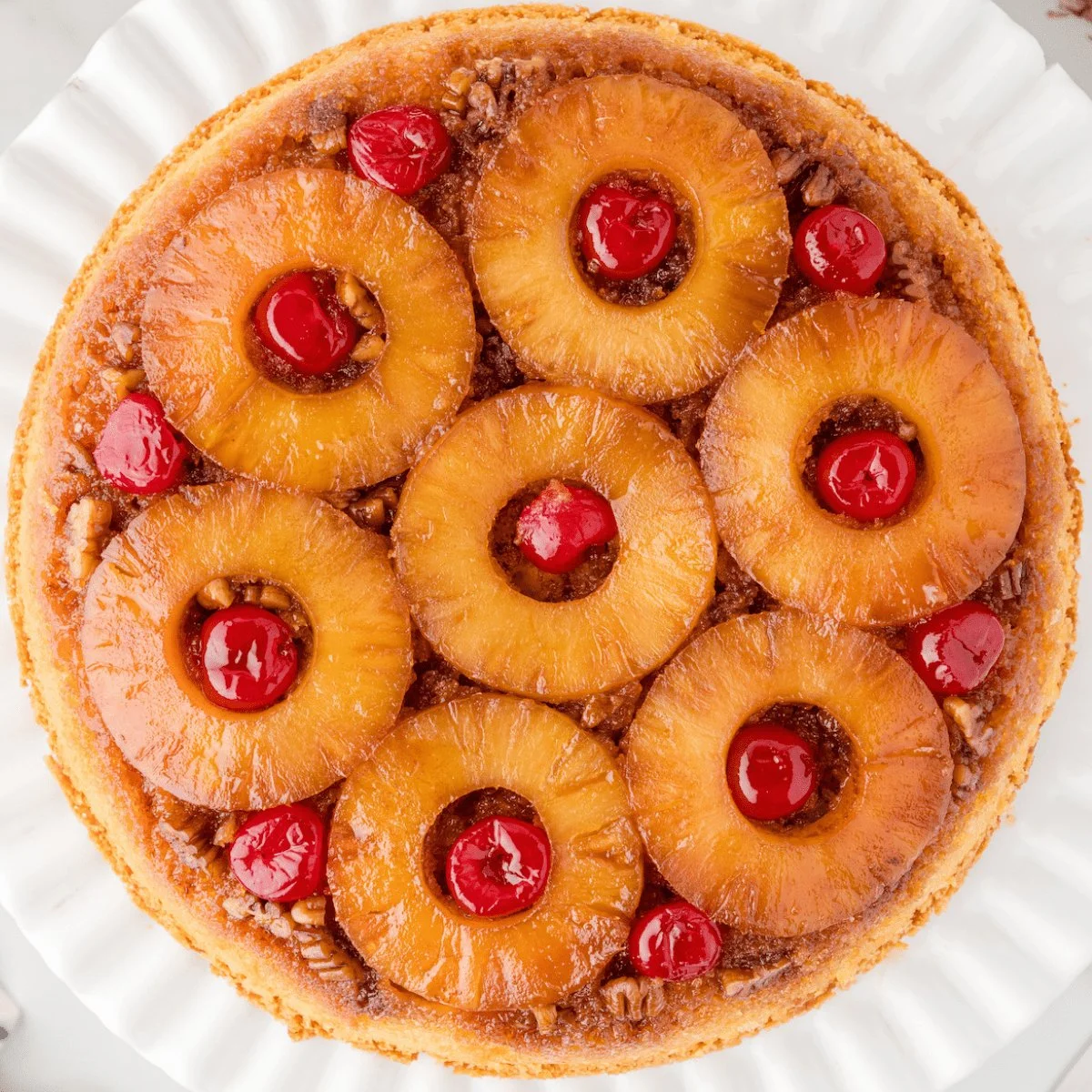 Delicious Skillet Pineapple Upside Down Cake served warm with pineapple and cherries.