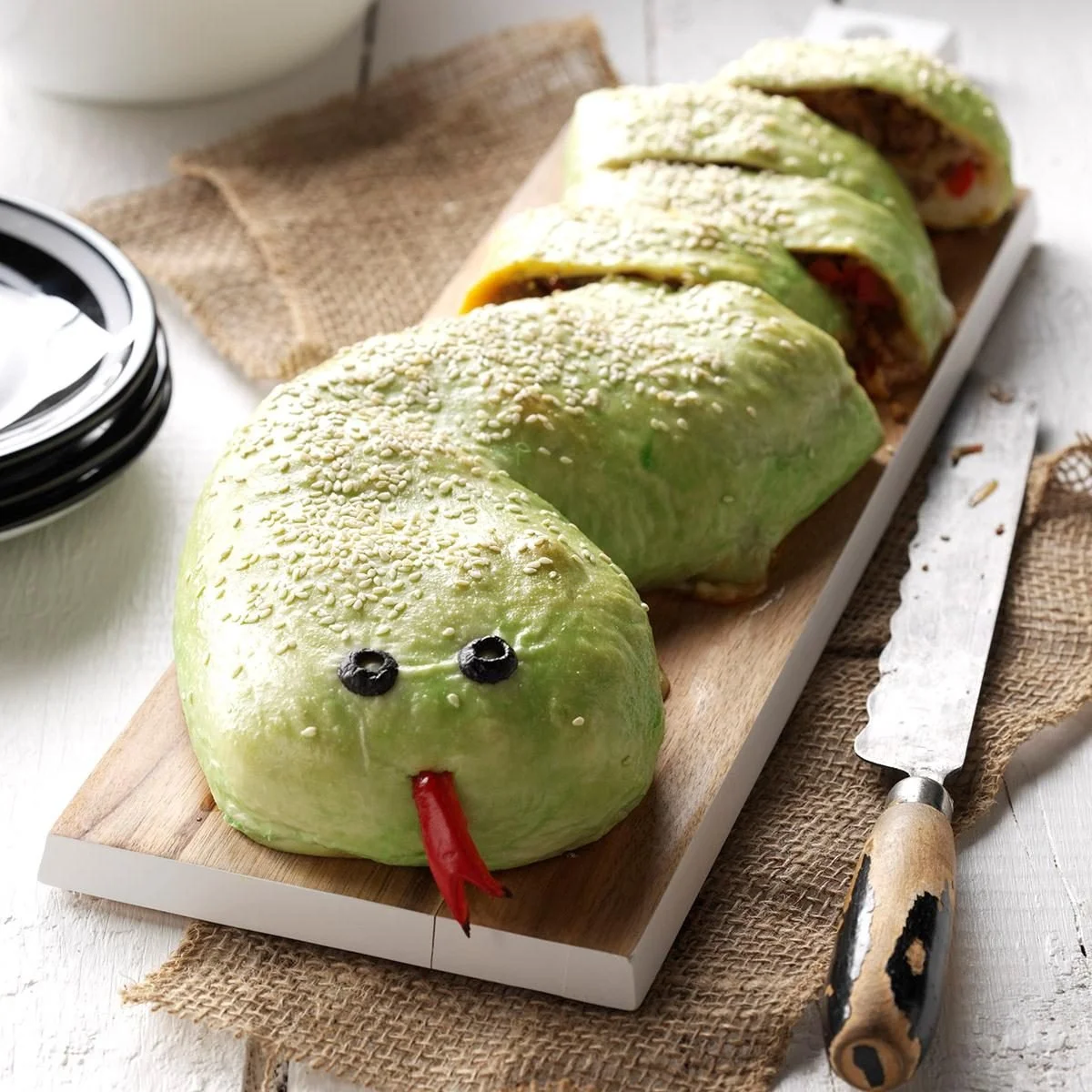 Slithering snake roll sushi with fresh ingredients on a plate