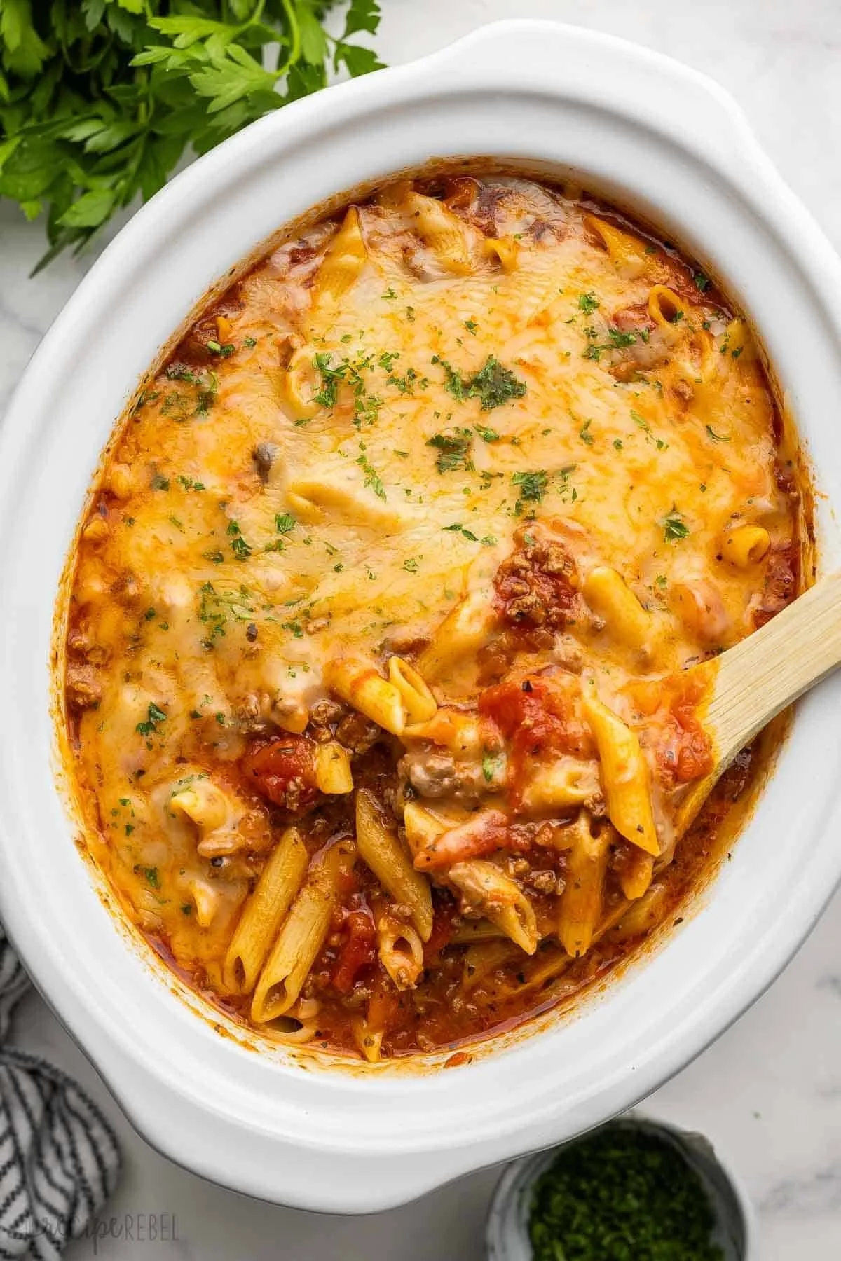 Delicious slow cooker baked ziti topped with cheese and herbs
