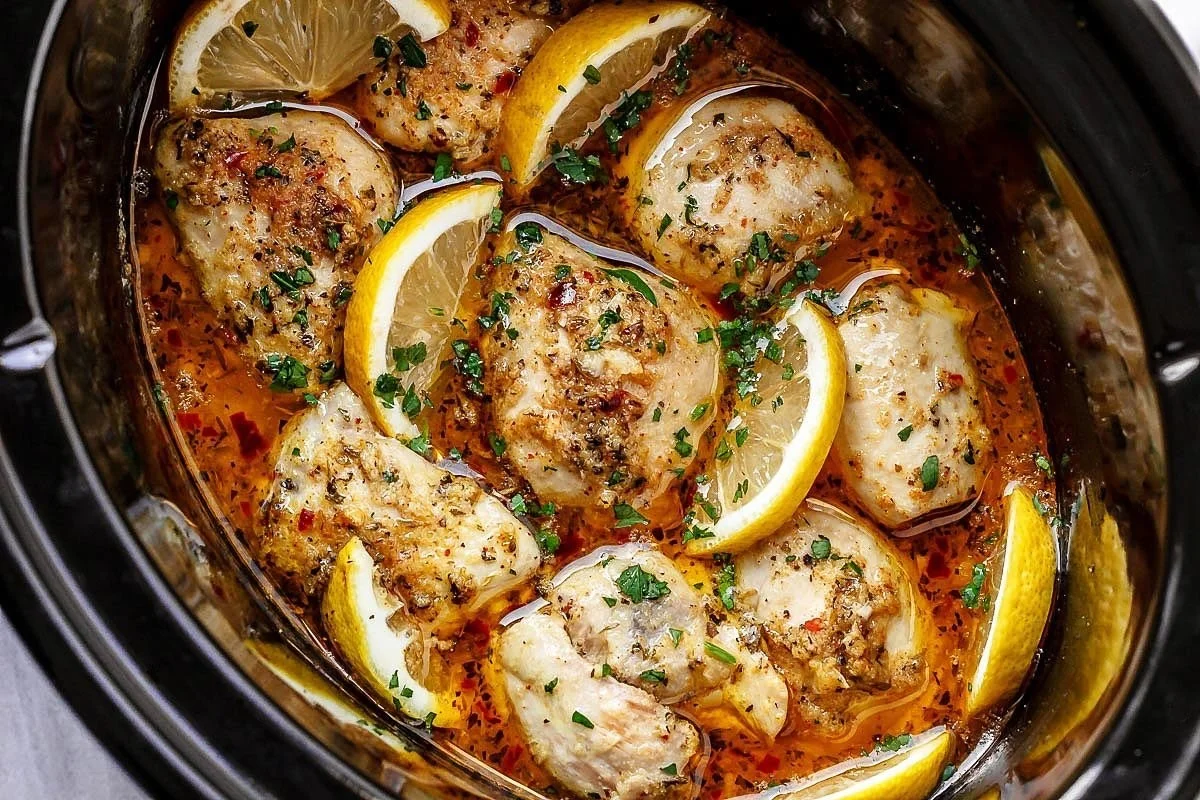 Slow cooker chicken thighs cooked in lemon garlic butter sauce.