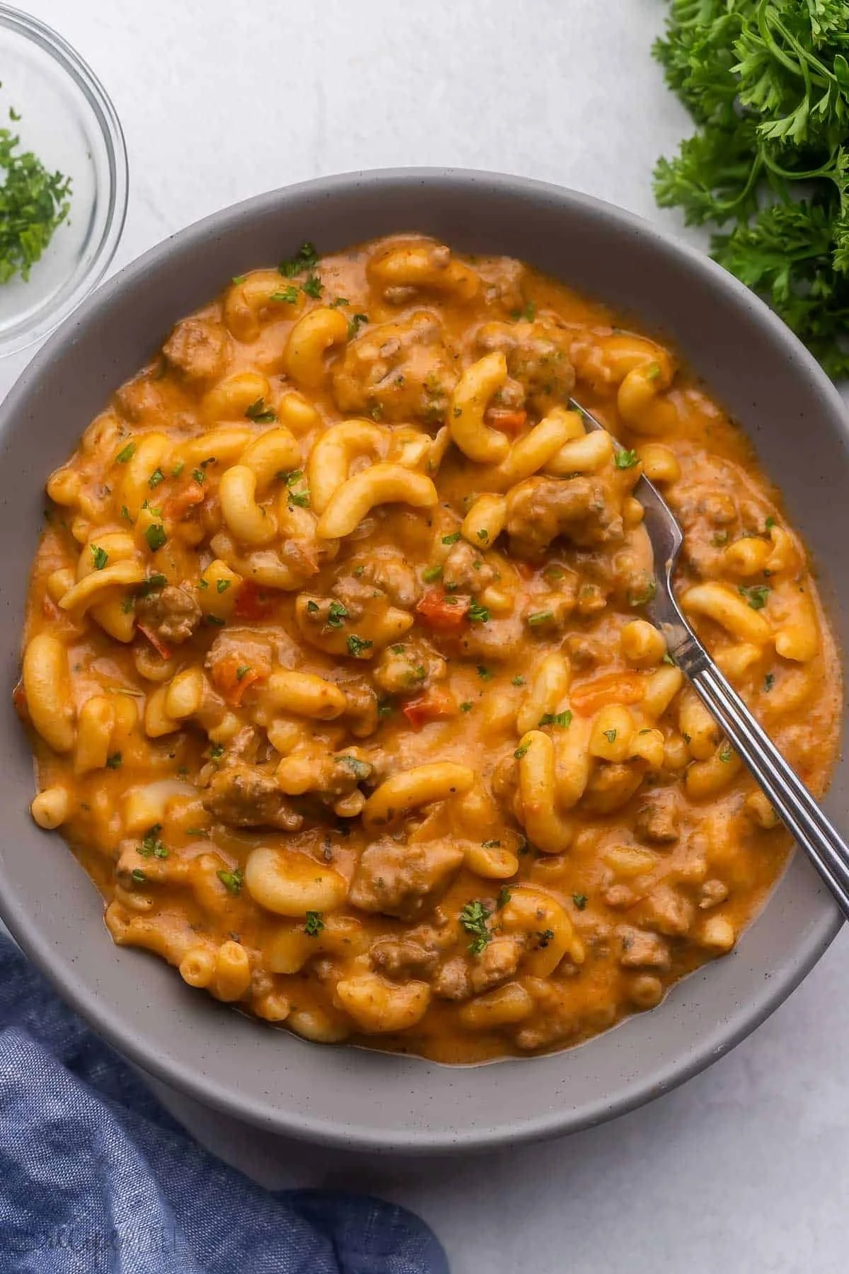 Slow Cooker Hamburger Helper cooking in a crockpot with ingredients.