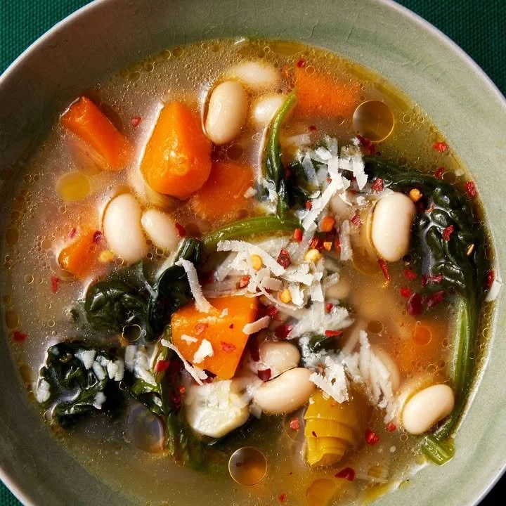 Bowl of Slow Cooker White Bean Soup garnished with parsley and served hot.