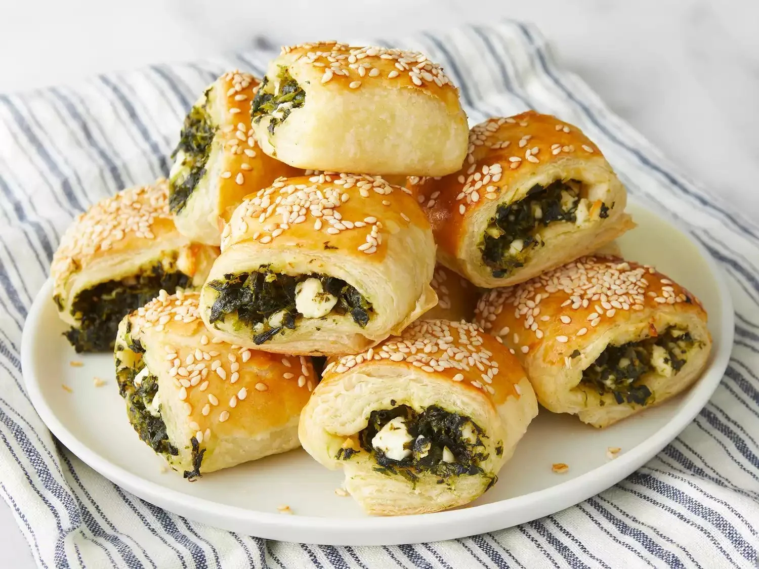 Homemade spinach rolls with puff pastry served on a plate
