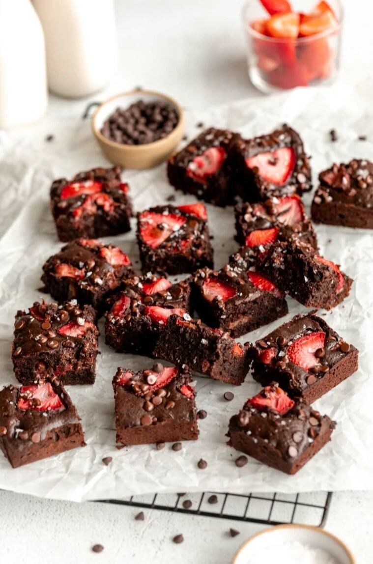 Delicious Strawberry Chocolate Brownies topped with fresh strawberries and chocolate sauce