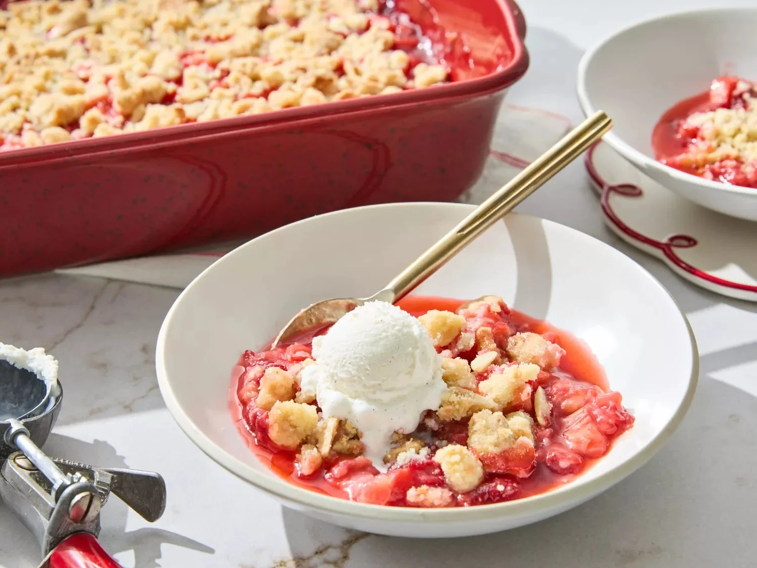 Delicious strawberry rhubarb crumble served in a dish, topped with a golden crumble.