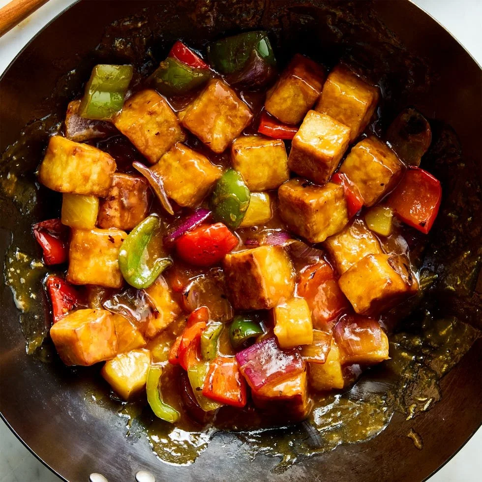 Delicious sweet and sour tofu served with colorful vegetables