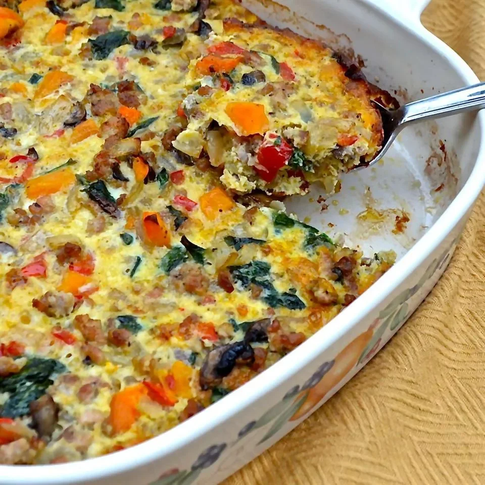 Sweet Potato Breakfast Bake topped with nuts and spices in a baking dish