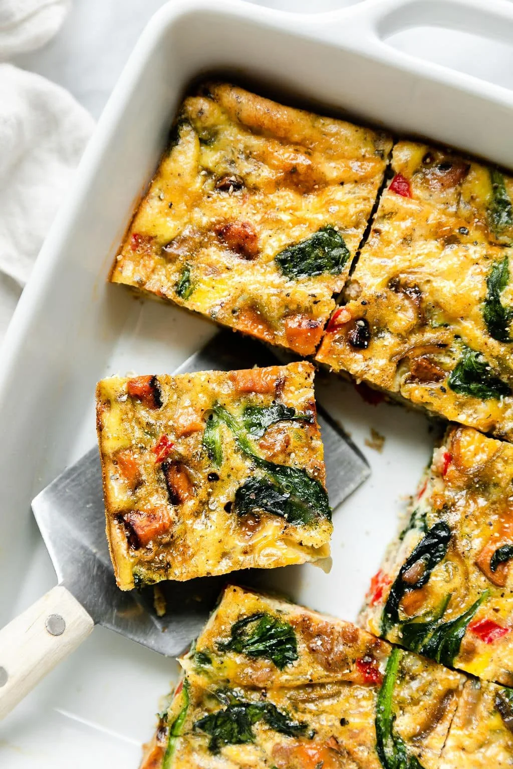 Delicious Sweet Potato Breakfast Casserole topped with herbs and cheese