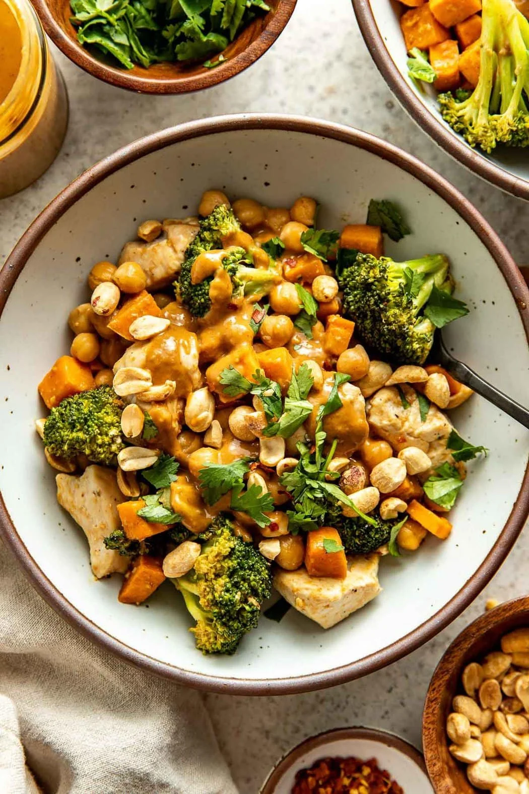 Thai-inspired chicken sweet potato peanut bowl with vibrant colors and fresh ingredients.