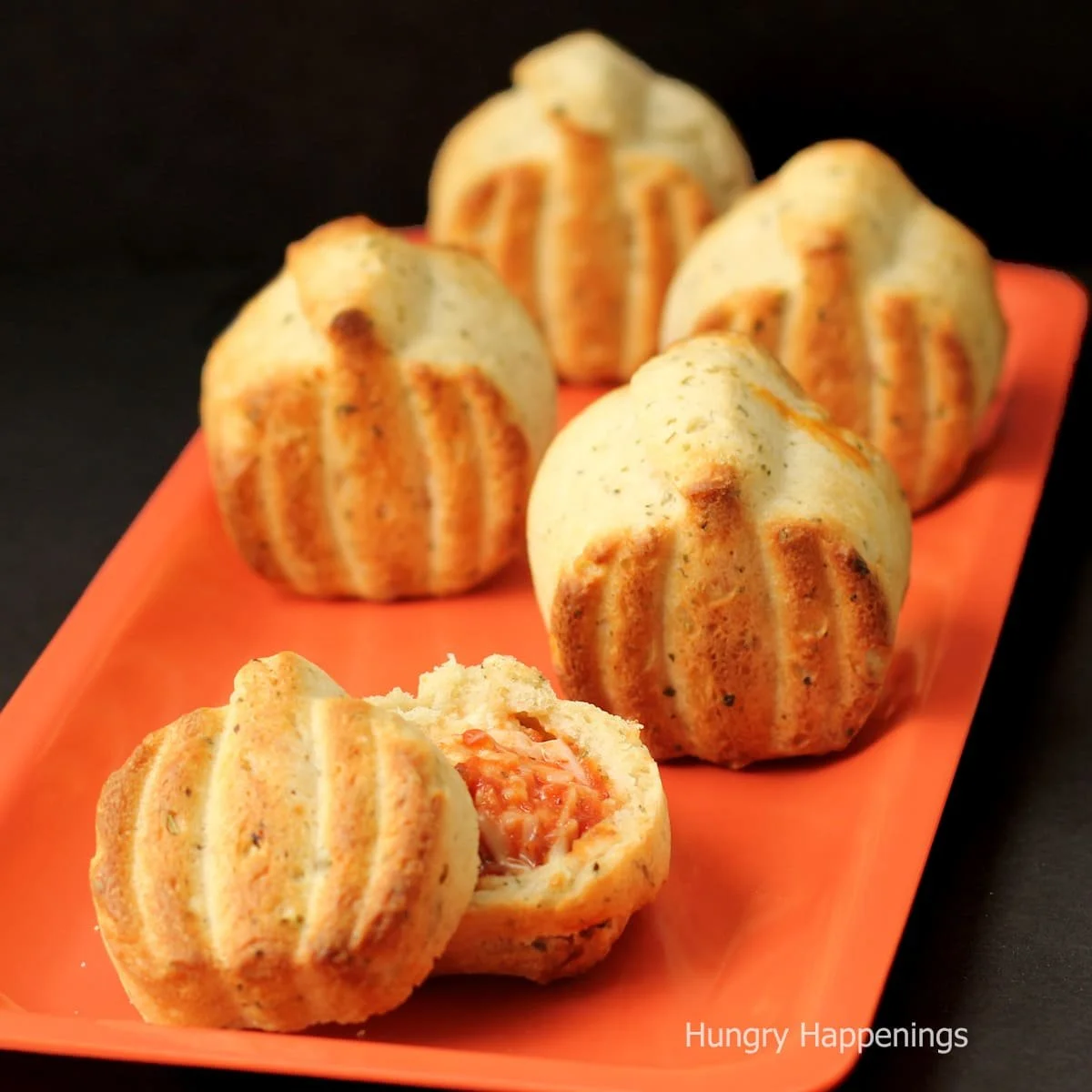 Three cheese calzone pumpkins filled with gooey cheeses and a crispy crust