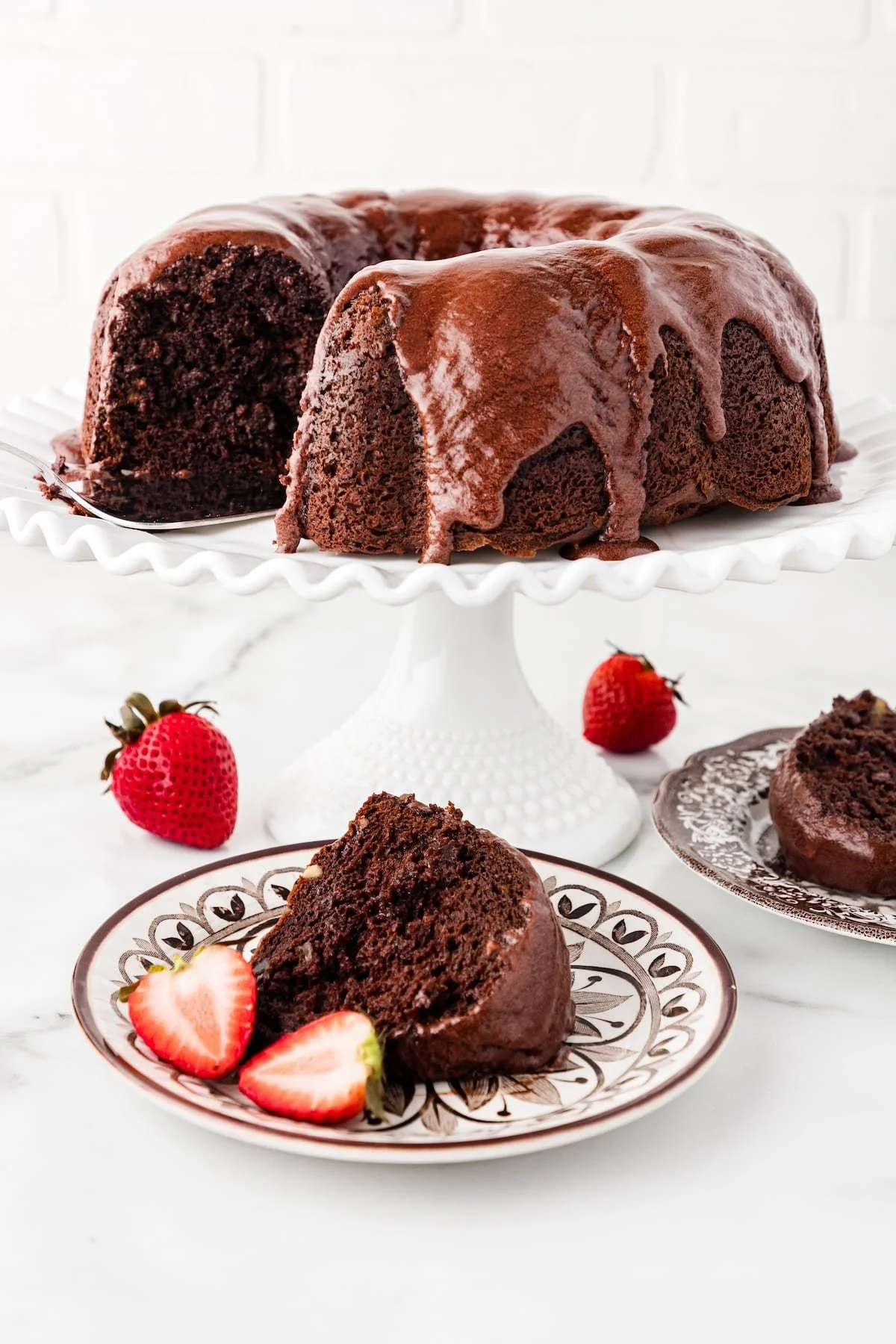 Decadent triple chocolate cake served with rich chocolate frosting and shavings.