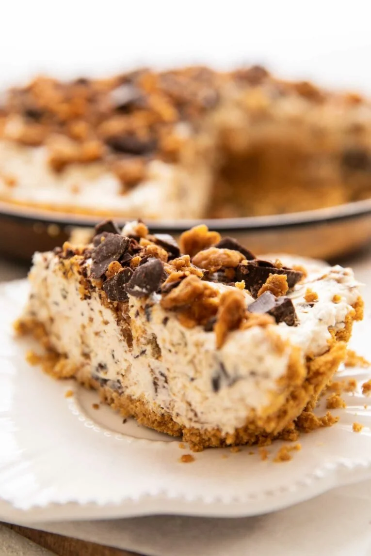 Vegan Butterfinger Cheesecake topped with chocolate and peanut butter