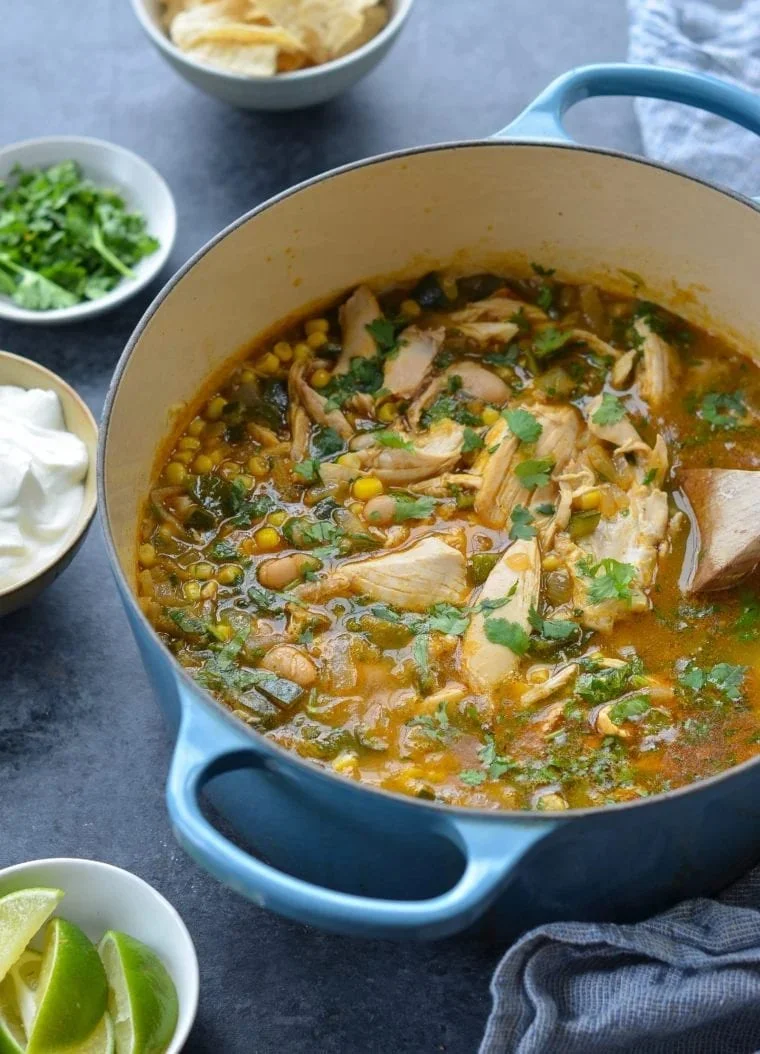 Bowl of White Chicken Chili topped with cilantro and served with crispy tortilla chips