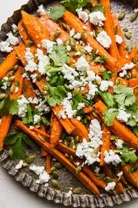 Plate of Za’atar Roasted Carrots garnished with herbs