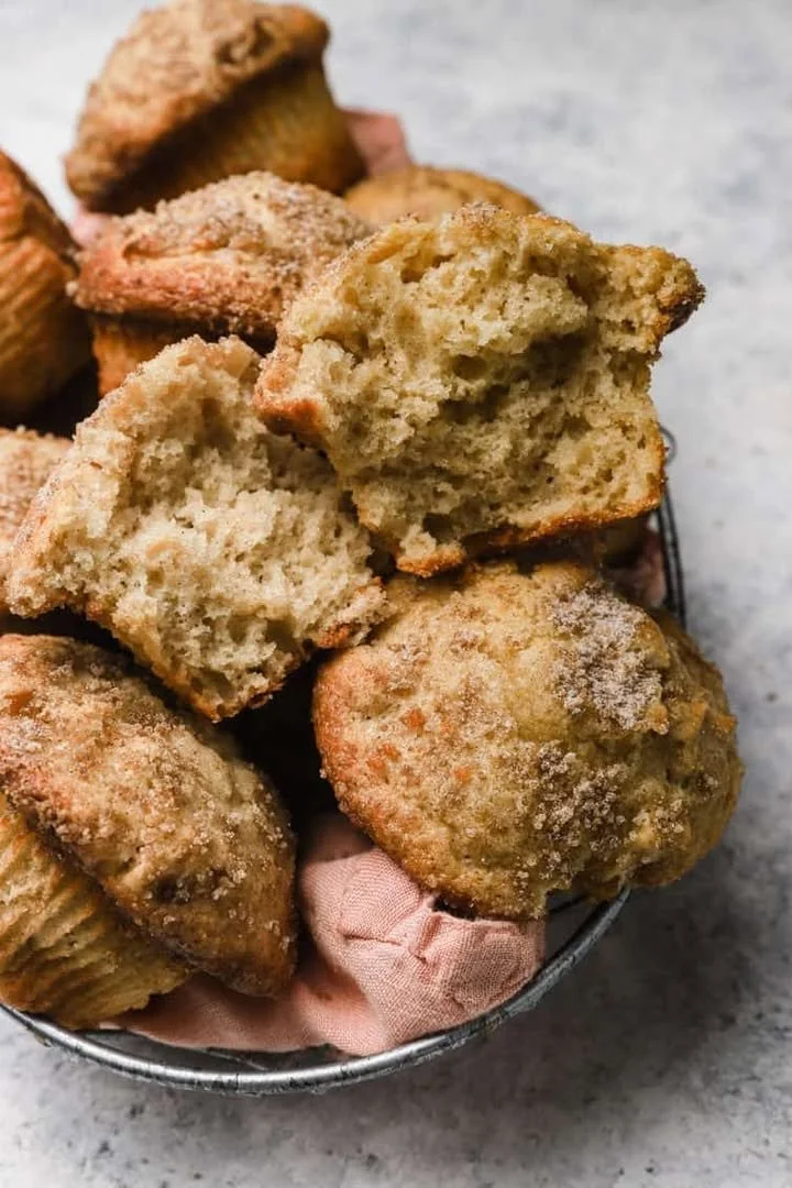 Freshly baked Apple Cinnamon Muffins with chunks of apples and a sprinkle of cinnamon