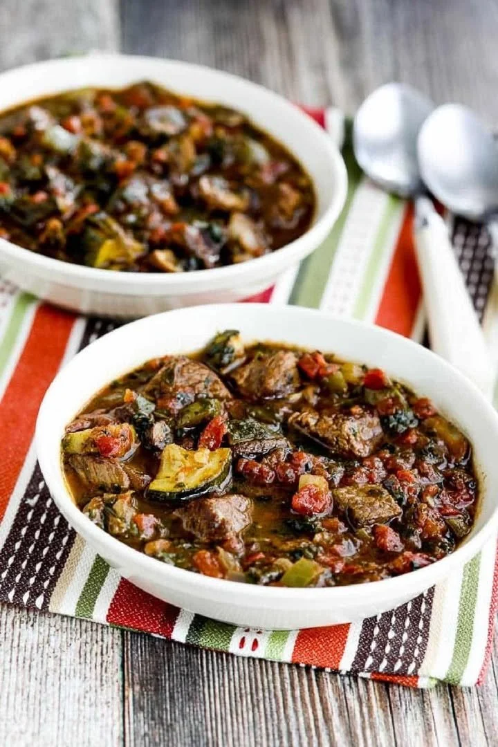 A bowl of Italian beef stew garnished with herbs and vegetables