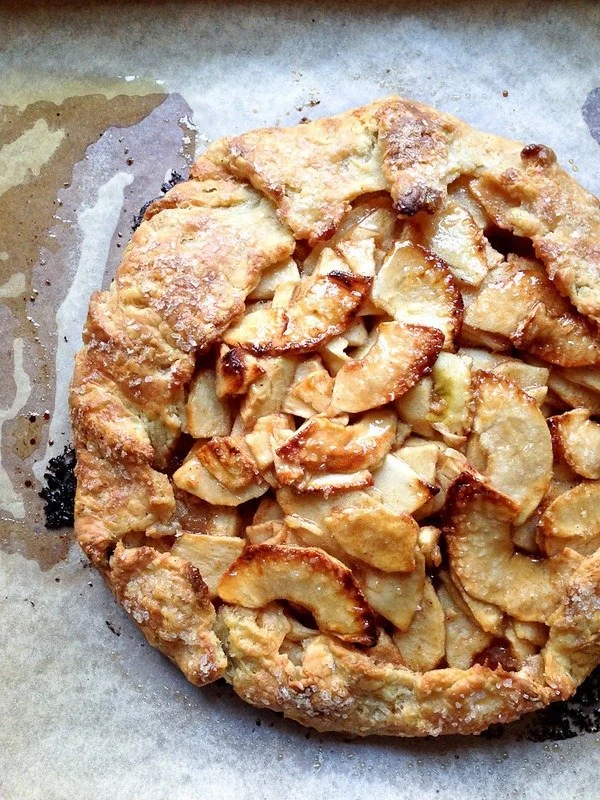 Delicious maple glazed rustic apple tart on a rustic wooden table