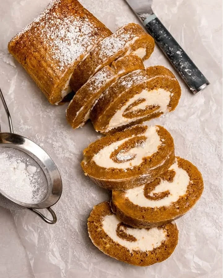 Delicious pumpkin roll dessert filled with cream cheese frosting and spices