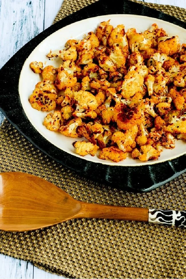 Roasted spicy cauliflower dish garnished with herbs and spices